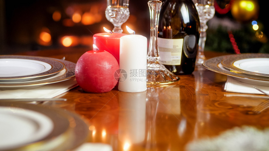 晚餐桌上烧蜡烛的紧贴照片用于在壁炉的浪漫晚餐图片