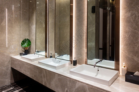 现代大理石陶瓷洗盆在公共厕所餐厅或旅馆购物中心厕所室内装饰设计背景图片