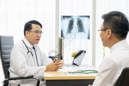 专业医生向诊所院病人解释X光检查结果背景图片