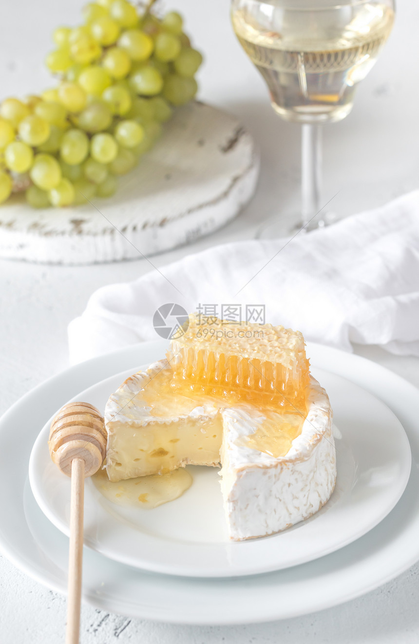 白瓷盘上含有蜂蜜和奶酪图片