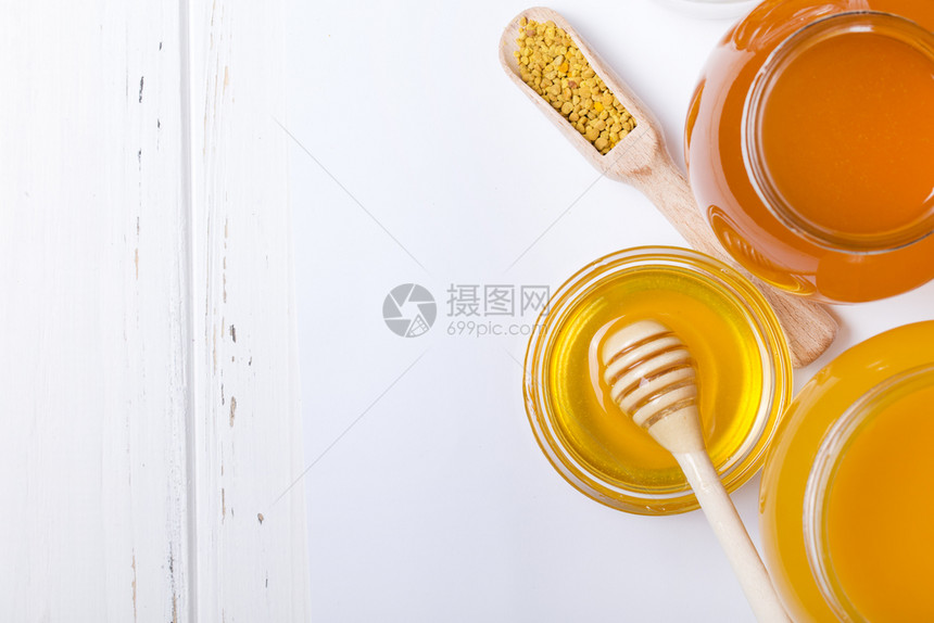 在白色背景的罐子里蜂蜜和图片