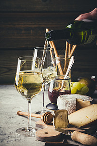 白葡萄酒倒进杯子在石本背景上加料类高清图片