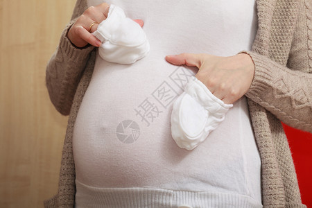 孕妇手拿小白袜子图片