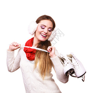 女孩戴耳罩温暖跳跃者戴着滑冰的红色围巾被孤立图片