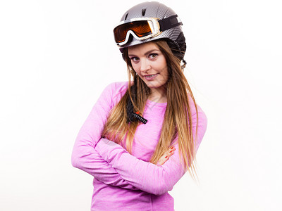 冬季运动爱好者概念戴运动头盔的女人穿粉色衣服的年轻女士图片