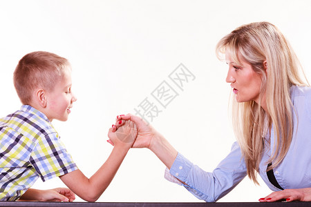 与家庭乐趣和纽带共度时光母亲和儿子在室内摔跤和玩乐母亲儿子在桌上摔跤图片