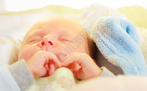 婴儿护理童年概念的美丽小新生婴儿在床上安睡被毯子包围小新生婴儿在毯子中安睡背景图片