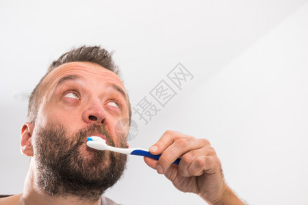 照顾口腔卫生清晨洗手间例行工作时刷牙的人在洗手间刷牙背景图片