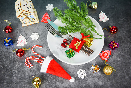 圣诞餐桌位装饰圣塔克拉乌斯帽子叉和餐盘圣诞节新年晚宴圣诞的背景图片