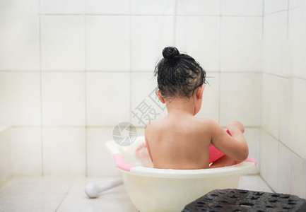 儿童淋浴室亚洲女童洗澡和打水图片