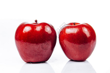 白色背景的鲜红苹果美的反光图片