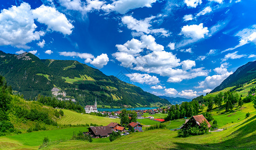 伦格勒西SwissLungern村的全景以及Lungense湖上的教堂和传统木屋阳光明媚的夏日瑞士ObwaldenObwalden瑞士L背景