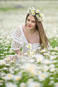 小雏菊花环卡莫米尔草地的可爱女孩美丽的户外肖像场景背景