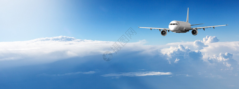 飞机在蓝天白云中飞行的全景图片