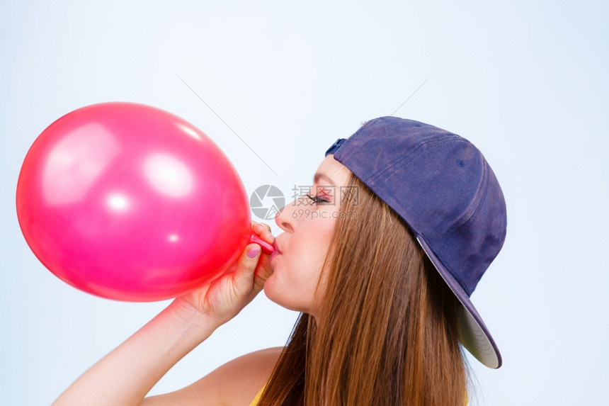 青少年和聚会为庆祝做准备特伦迪少女吹红气球年轻美女为派对准备配件青少年女孩吹红气球图片