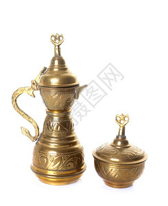 白色背景前的黄铜茶壶图片