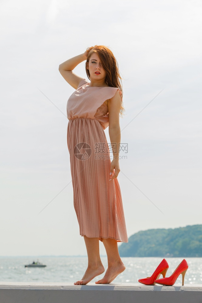 妇女穿着漂亮的长粉红裙子穿着长的粉红色裙子图片