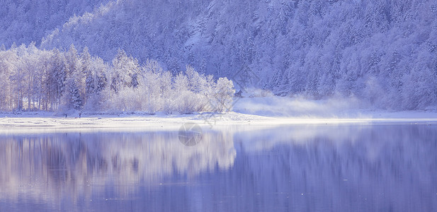 古时冬季风景反射湖雪树和山丘高清图片