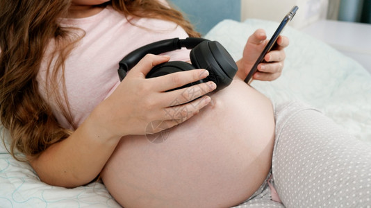 孕妇持耳机听音乐图片