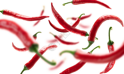 红色热辣椒在白背景上漂浮红色热辣椒在白背景上漂浮背景图片