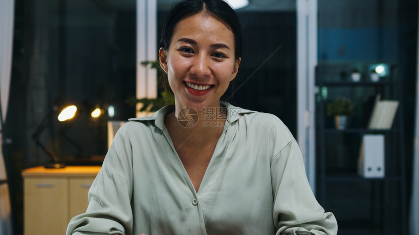 年轻亚洲女士在家的视频电话会议中与同事交谈图片