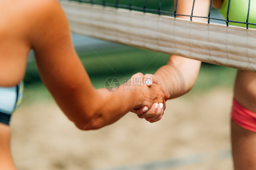 海滩排球女孩在比赛后握手图片