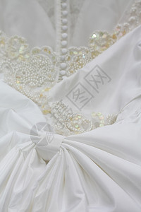 白婚礼服或带有珍珠和白按钮的婚纱背景图片