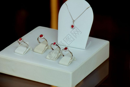 红色光环古老的钻石订婚戒指在商店窗口中红宝石与钻光环背景