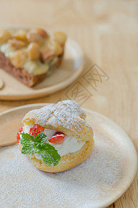 把草莓奶油和澳洲坚果蛋糕放在木盘上草莓酱图片