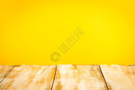 黄色墙壁背景的木桌顶图片