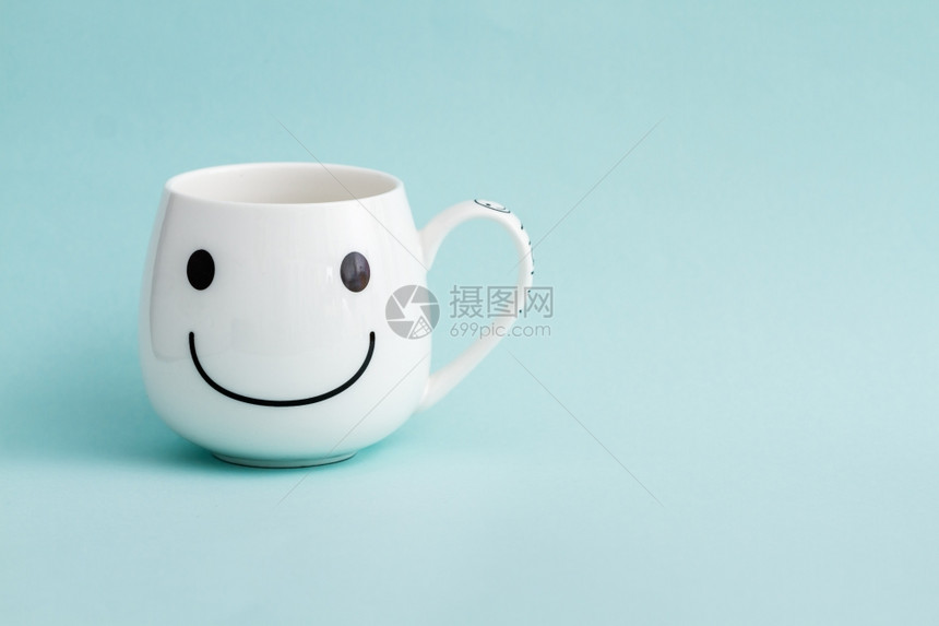 绿色背景的笑脸白咖啡杯图片