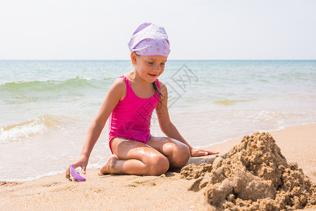 女孩在海边开心的玩沙子图片