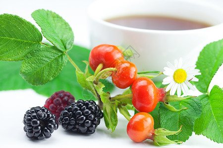 黑莓茶茶杯黑莓草焦米和玫瑰花果白背景叶子背景