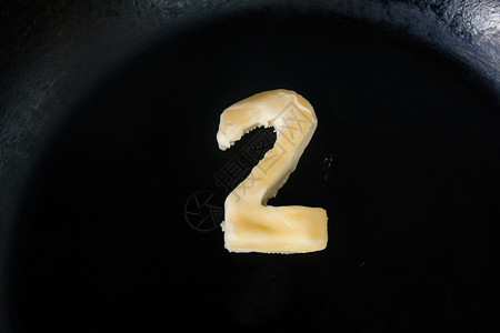 热锅上的黄油以2号形状关闭顶部视图图片