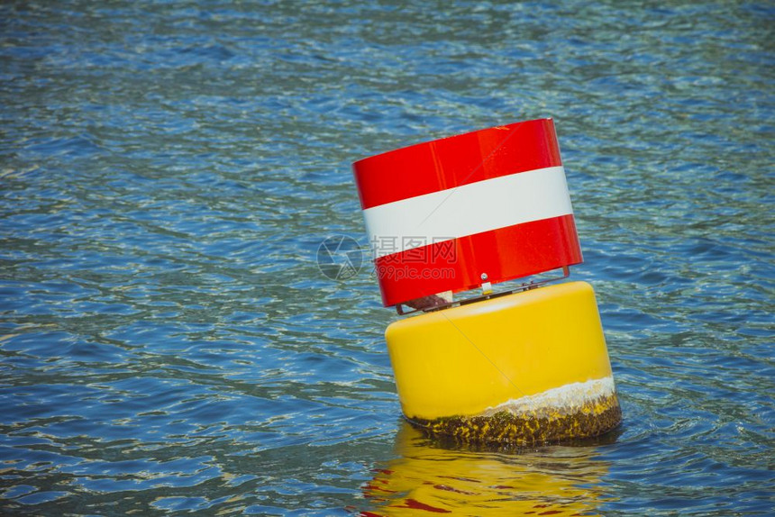 蓝色海水中的黄红白钢航行浮标图片