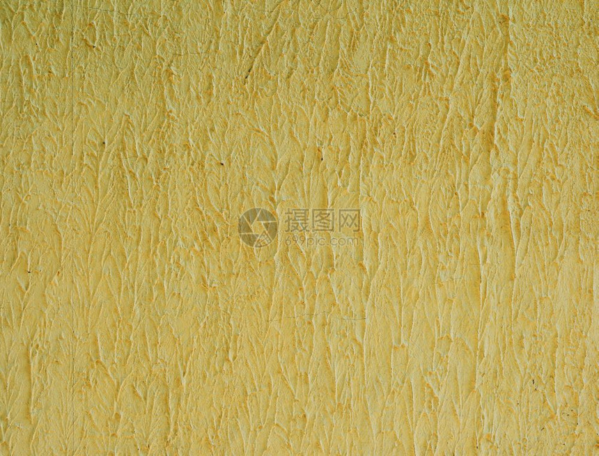 水泥黄色墙大体结构的碎块图片