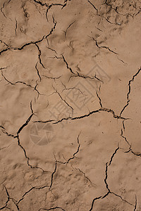棕色干燥碎裂泥土作为背景纹理高清图片
