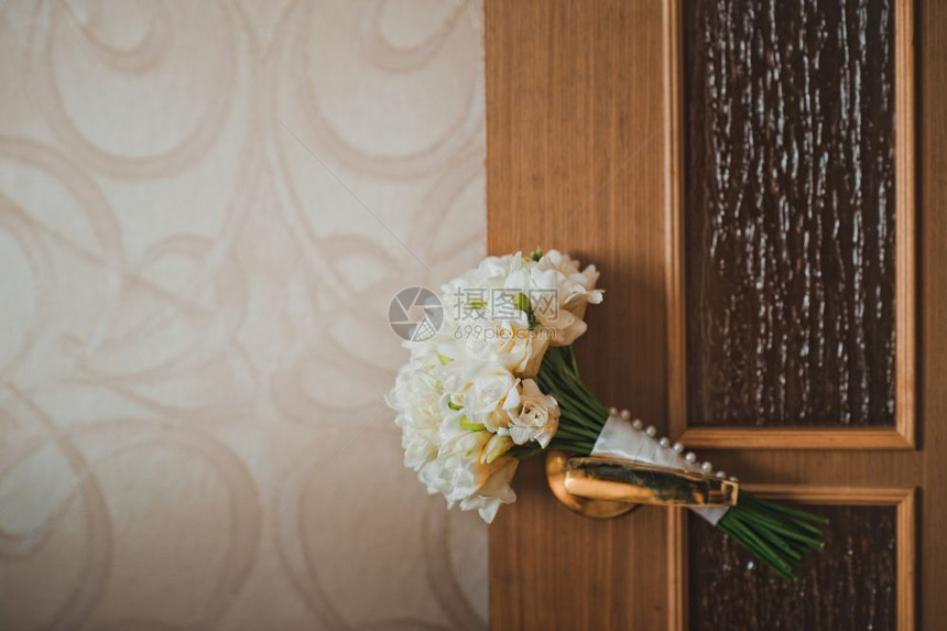 新娘花束就放在房间里的门把手上图片