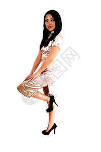 一个漂亮的年轻女人穿着长银色的裙子黑发白色背景图片