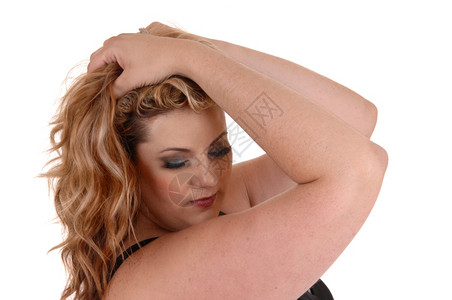 一个金发又大的女人双手握在头顶俯视着与白人背景隔绝图片