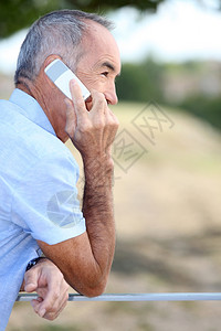 老年人在户外使用移动电话说图片