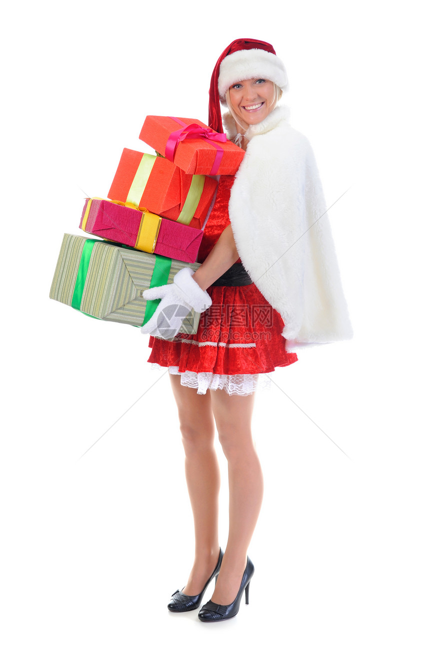 圣诞微笑的女士穿着红色的圣诞礼帽带着物孤立在白色背景上图片
