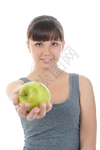 手握着绿苹果的体育女孩孤立在白色背景上图片