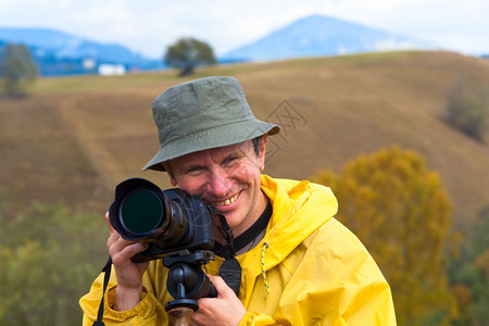秋季山地背景的笑摄影师肖像快乐图片