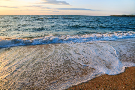 海浪在日落沙岸线上断浪图片