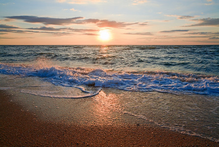 海日夕阳冲浪沙海岸线的大浪断开图片