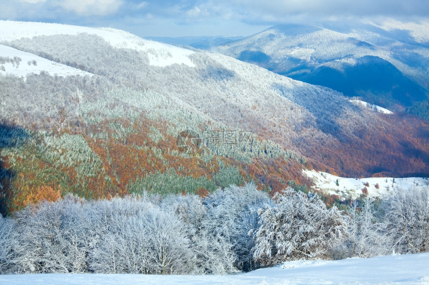 十月山尖森林边缘第一次冬天下雪去年秋在远山边图片
