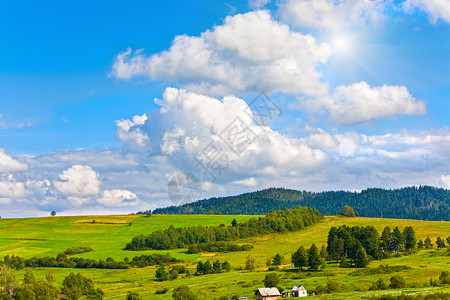 夏季山景与村郊和蓝天阳光照图片