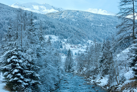 温山流雪林和丘上的村庄奥地利图片