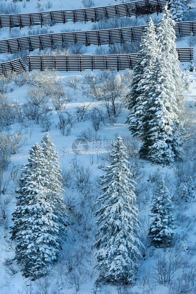 冬山坡上有雪壁和金属的屏障图片